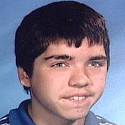 Image depicts Daniel Leubner - a teenage boy with short brown hair, lightly biting his lower lip with the hint of a smile.