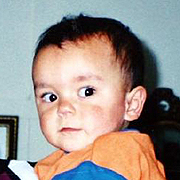 Image depicts Daniel Thomas - a young Caucasian boy with short dark hair and big dark eyes.