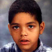 Image depicts Gabriel Britt - a young boy with close cropped black hair facing the camera with his eyes intensely focused and his mouth slightly open.