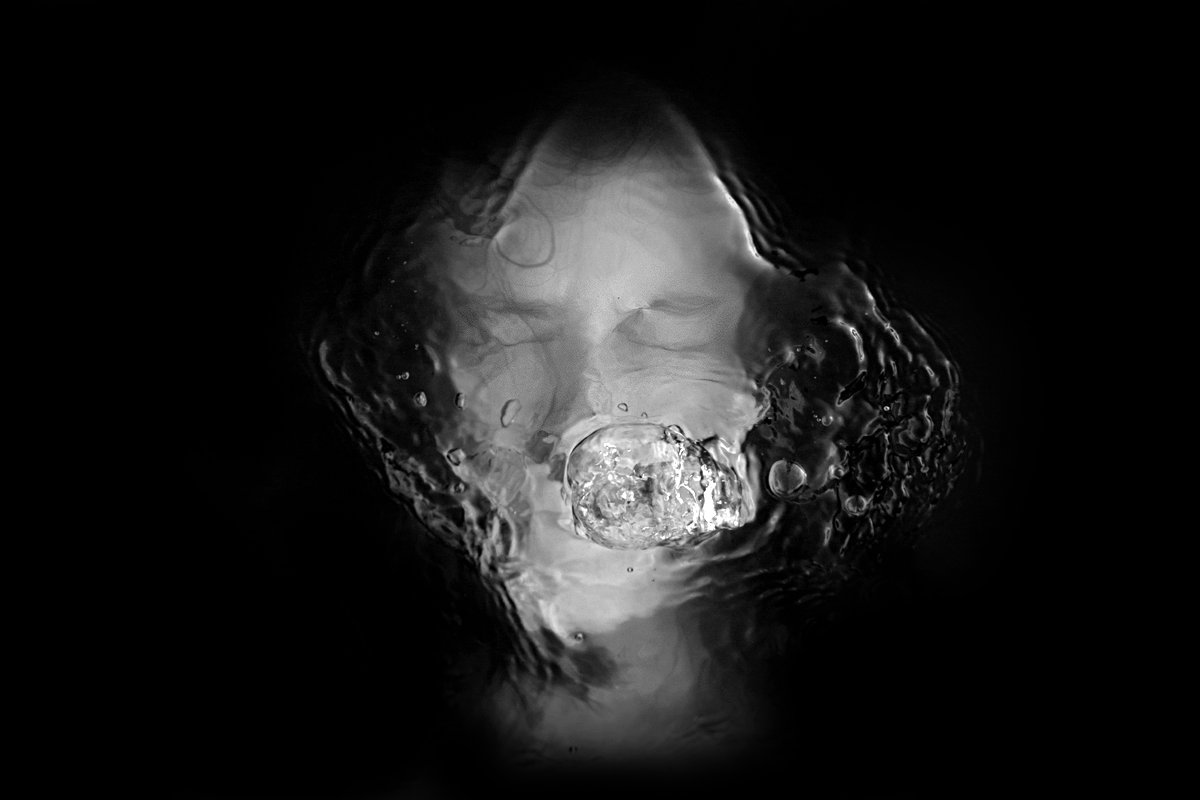 Black water, just under the surface a person silently screaming. Bubbles are raising from the person's mouth towards the water's surface. I visual representation of Selective Mutism.