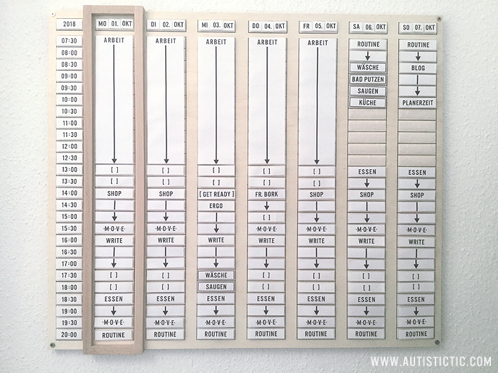 A large wooden weekly planner hanging on a white wall. It has columns for each weekday and rows for times in 30-minute increments. It is filled with signs creating a weekly schedule.