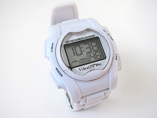 White wrist watch with white silicone band and digital display.