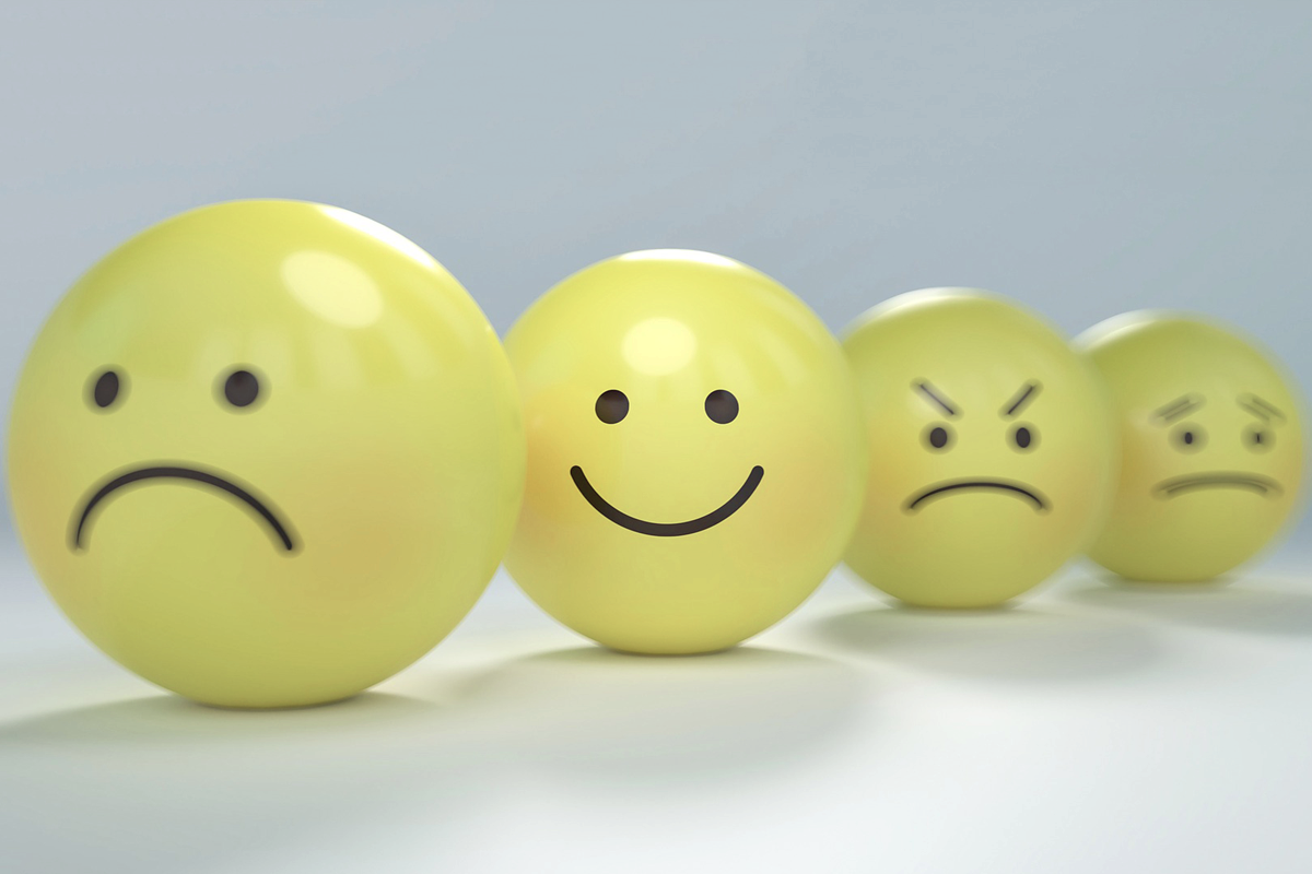 Grey background with four yellow emoticons in a row. The first has a sad face, the second happy, the third angry, the fourth worried.